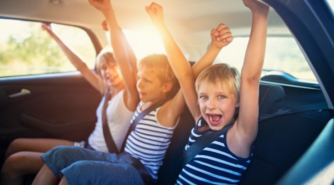 Kids having fun in car on a road trip_istock