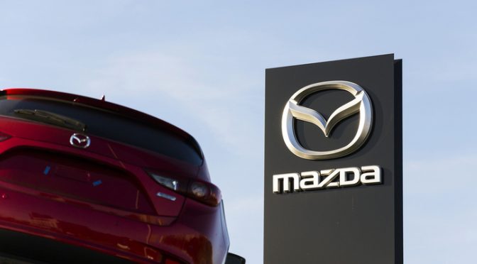 Mazda 3 car in front of dealership building