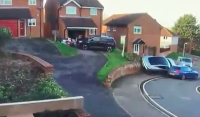 Porsche ramps over wall and into another car