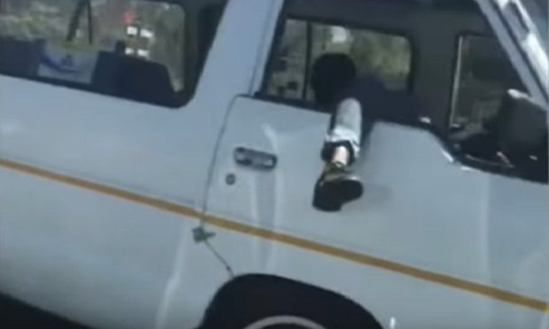 WATCH: Taxi driver filmed driving with his leg hanging out the window