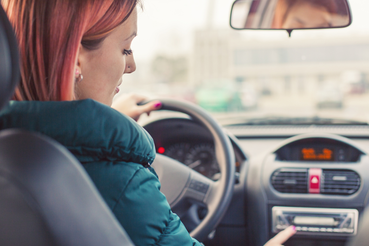 Women changing radio in car | Women On Wheels