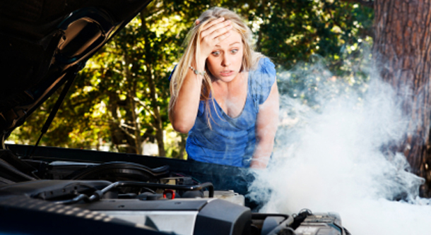 car overheating - girl looking at engine