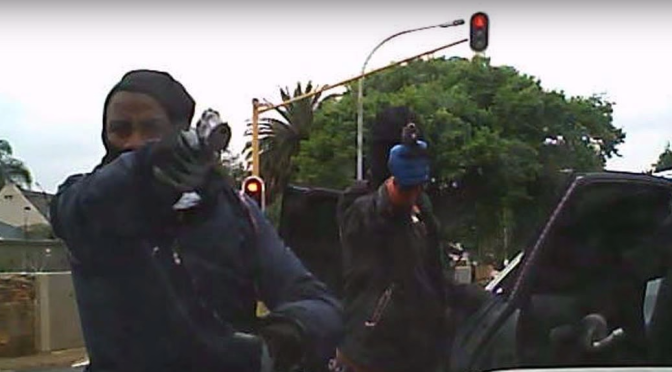 woman hijacked - man pointing gun towards camera