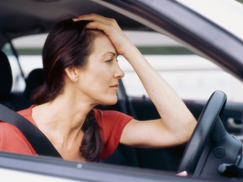Woman looking unhappy in a car